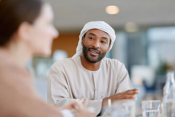 Arab businessman discussing with colleague during office meeting