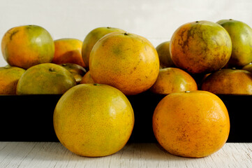  tangerine orange fruit on wooden background