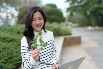 Young woman learning about nature using technology outdoors