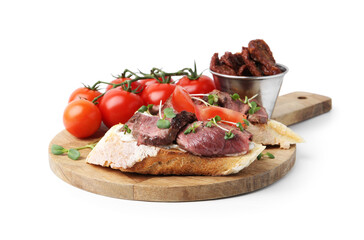 Delicious bruschettas with roast beef, cream cheese, tomatoes and microgreens isolated on white