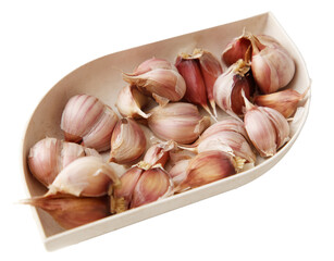 A white bowl with a bunch of garlic in it