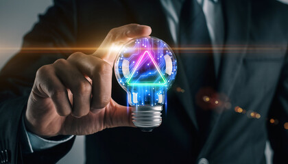 Illuminating Innovation: A poised individual grasps a glowing light bulb, a visual metaphor for brilliant ideas, invention, and future-forward thinking.