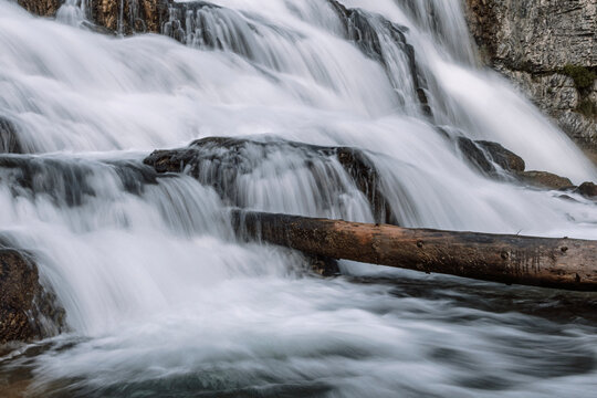 log in the middle of waterfall, long exposure, Wyoming