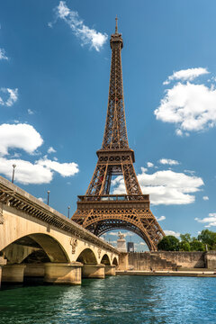 Paris France Eiffel Tower rising from banks of Seine River waterfront