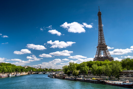 Paris France boats move along Seine River near Eiffel Tower