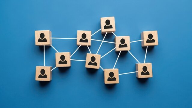 Connecting wooden blocks with people icons representing a network on a blue background