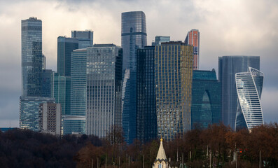 Moscow-City modern skyline with river and autumn foliage