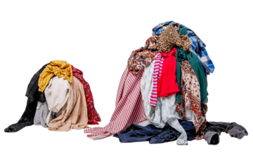 Two piles of second-hand clothes. Sorting used clothes.