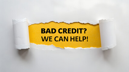 Torn white paper revealing yellow background with black text message asking bad credit we can help isolated on white background