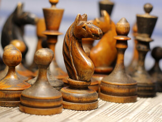 Old retro wooden chess pieces, intellectual strategy game.
