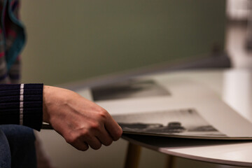 Close-up photograph of human hands flipping through a magazine. Clear details of the paper, texture, and page movement. Perfect for lifestyle imagery, education, reading habits, print media