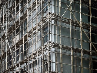 Bamboo scaffolding with building under construction with scaffolding, Hongkong Construction Safety, bamboo sticks