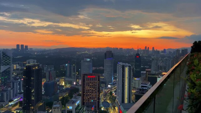 Kuala Lumpur, Malaysia, June 8, 2025: Sunset from an observation deck in Kuala Lumpur. Sunset sky illuminated by twilight, TV tower, and high-rise buildings from the air in the city center. 4K