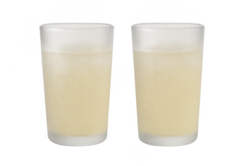 Two frosted glasses of cold lemonade refreshing drink on transparent background