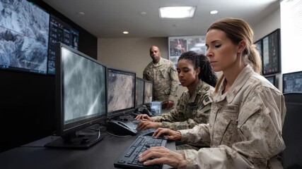Military personnel operate advanced technology in a monitoring room, analyzing real-time data for strategic decision-making in a secure facility