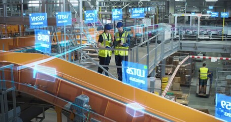 Two Warehouse Engineers in Monitor a Smart Parcel Conveyor, Using a Digital Tablet and Holographic Data Visualisations to Track Shipment, Optimise Distribution, Manage Logistics in Automated Hub. - Powered by Adobe