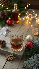 Whiskey, brandy or liquor shot and Christmas decorations on wooden background. Winter holidays concept.
