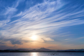 ダイナミックな空と霞ヶ浦から望む筑波山の夕景