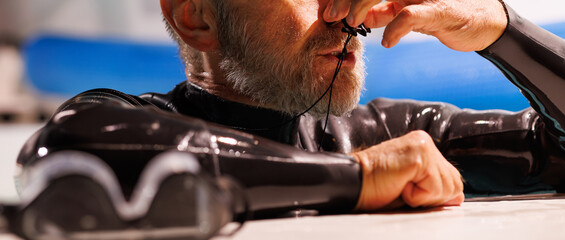 Banner of diver in wetsuit using nose clip near blurred goggles on poolside 