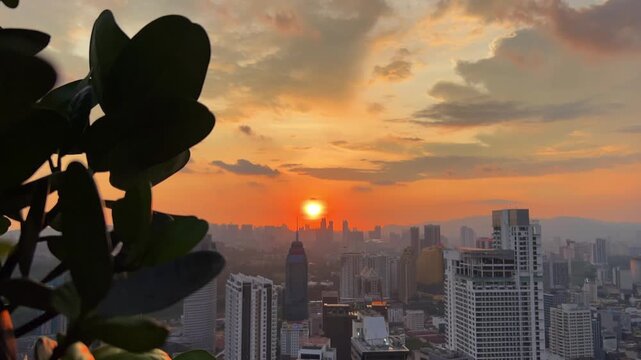 Kuala Lumpur, Malaysia, June 8, 2025: Sunset from an observation deck in Kuala Lumpur. Sunset sky illuminated by twilight, TV tower, and high-rise buildings from the air in the city center. 4K