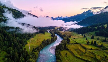 An aerial view of a river flowing through a lush green valley surrounded by mountains and forests, with clouds and a beautiful sunset sky.