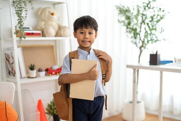 Asian schoolboy wearing uniform with backpack ready to learn at home, representing education, first day of school, childhood learning and academic preparation, education, back to school concept
