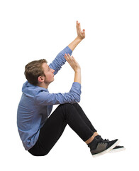 Side view scared teenage guy seated on the floor keeps hands raised to protect him from danger, full length sitting teen isolated on transparent background. Helpless adolescent victim of bullying