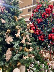 a Christmas tree decorated with squirrel toys and red balls
