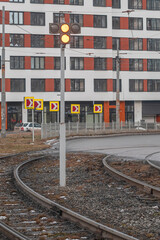 Tram traffic light on a city street on a winter day