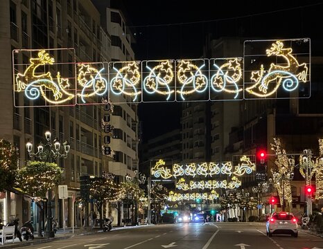 Festive Christmas lights adorn a city street at night in Vigo, Galicia, Spain, January 2024