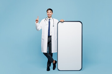 Full body young male doctor man wear white medical gown suit work in hospital clinic office big...