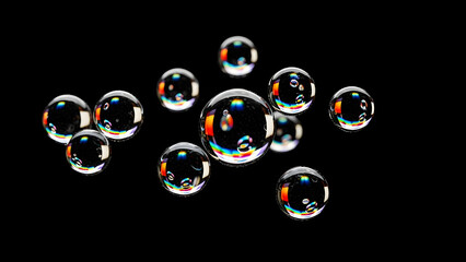 Close up of iridescent soap bubbles floating against a dark background