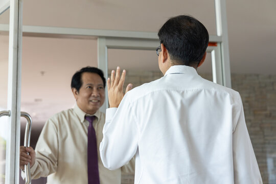 South East Asian businessman or office worker bumping into his colleague by chance, with surprised but happy mood