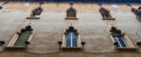 Verona, Italy. Traditional colorful building with balconies, shutter windows and multicolored walls...