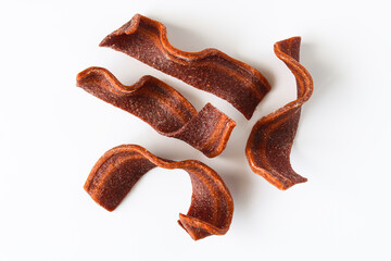 Realistic bacon style dog treats arranged against a bright white surface. Perfect for showcasing pet snacks, training rewards, and premium canine product imagery.