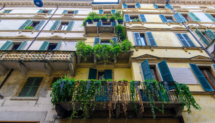 Verona, Italy. Traditional colorful building with balconies, shutter windows and multicolored walls in typical italian street	
