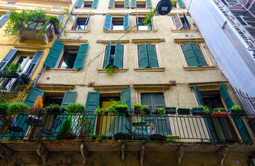 Verona, Italy. Traditional colorful building with balconies, shutter windows and multicolored walls in typical italian street	
