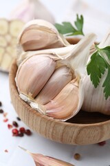 Garlic, peppercorns and parsley on white table, closeup