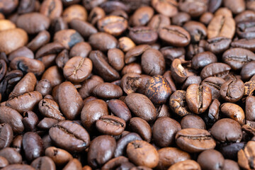 Detailed roasted coffee surface, Macro view of glossy roasted coffee beans surface, Highdetail macro shot showcasing oily roasted coffee beans with textured surface features
