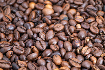 Detailed macro of roasted beans, Close perspective on shiny roasted coffee beans, High magnification photograph showcasing glossy surface of freshly roasted coffee beans