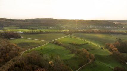 Aerial view with agricultural fields at sunrise on a sunny autumn day