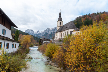 Autumn landscape in the Bavarian Alps with church and mountain river