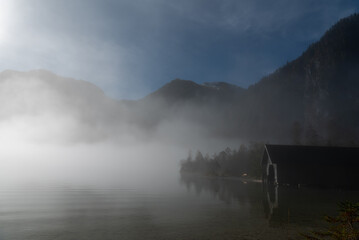 Autumn landscape with Lake Konigsee on a foggy morning