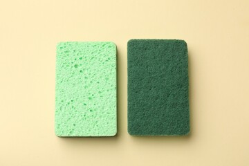 Kitchen sponges on beige background, top view