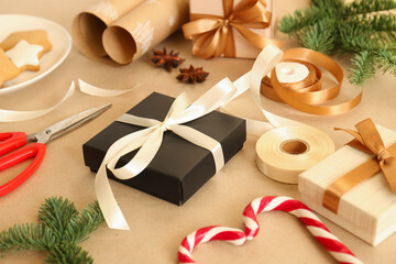 Christmas gift and wrapping materials on kraft paper background, closeup