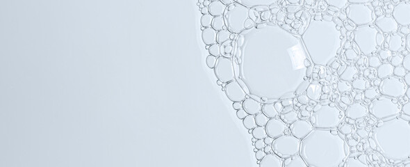 The texture of the foam of shower gel or soap suds or shaving foam. Macrophotography. Copy space