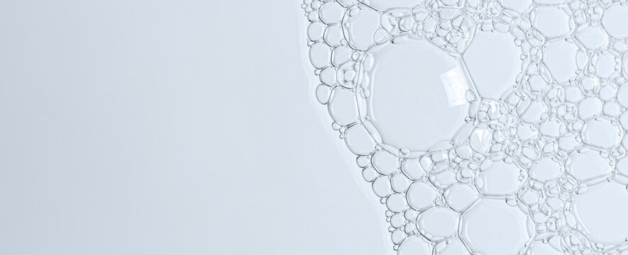 The texture of the foam of shower gel or soap suds or shaving foam. Macrophotography. Copy space