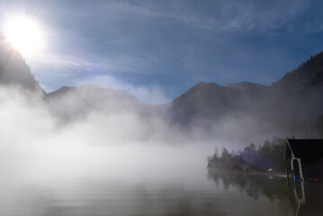 Landscape on a foggy morning in autumn at lake Konigsee