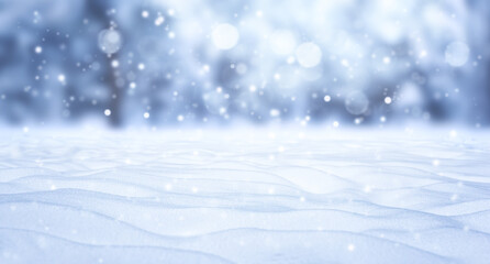A winter Christmas snow background with snowdrifts against a backdrop of snow-covered trees and a beautiful bokeh lights with snowflakes and garlands. Banner format, copy space.