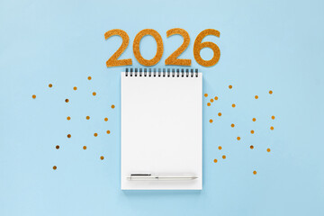 New Year 2026 planning concept with notebook and golden numbers for your goals, plans, resolutions. Flat lay style. Christmas planning concept with space for text